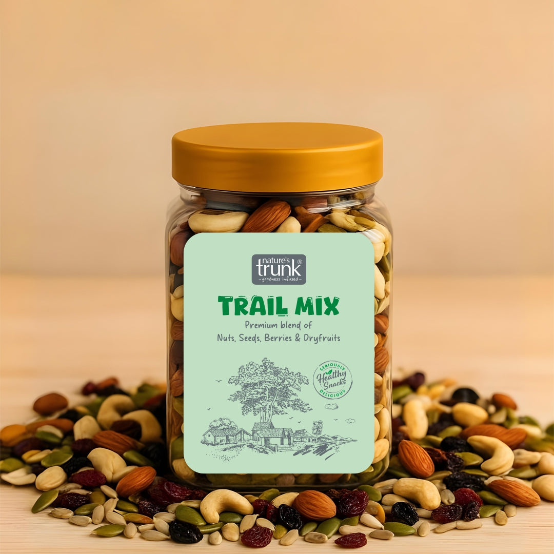 Jar of healthy trail mix with mixed nuts and seeds spilling out, highlighting a premium snack blend for daily energy