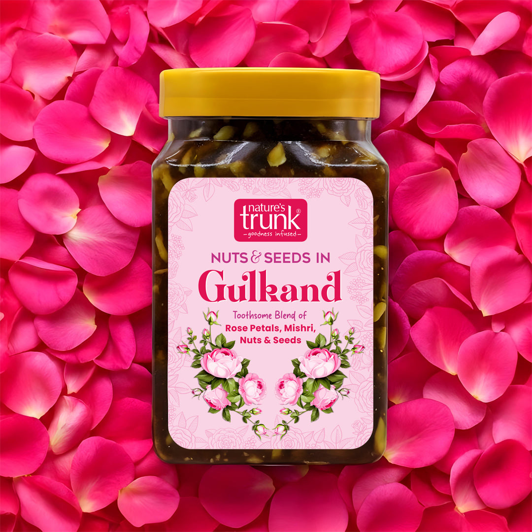 Jar of Nuts & Seeds in Gulkand with a pink label on a pink petal background